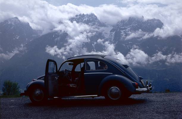 Driver seat view over the Alps mountains. Driving retro van along the roads of Ecrins National Park, France.