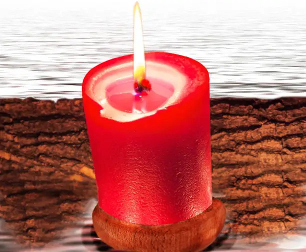 Photo of Composition from red candle and water