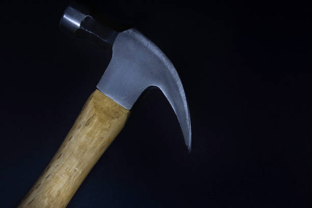 istock Hammer on a black background with nails 1252446818
