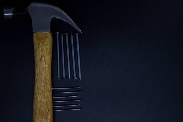 istock Hammer on a black background with nails 1252446963