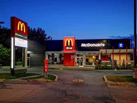 McDonald's McCafe and restaurant at blue hour photographed at the exit of the drive-through on a calm Summer night. This venue is on Sherbrooke street in the Angus residential district.