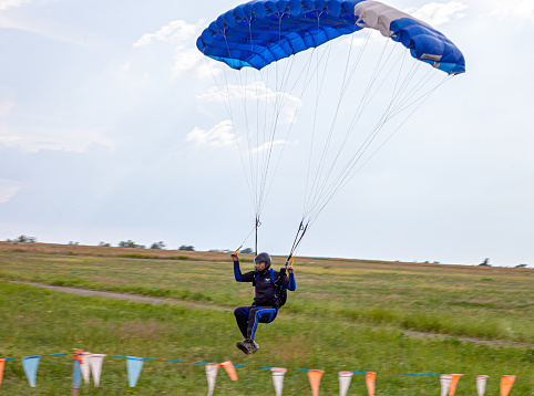 Kyiv, Ukraine - June 21, 2020: A parachutist with a parachute jumped and flew. Fly with a parachute. Sport.