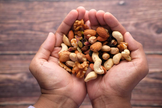 istock mixed nut on palm of hand top down 1252448522