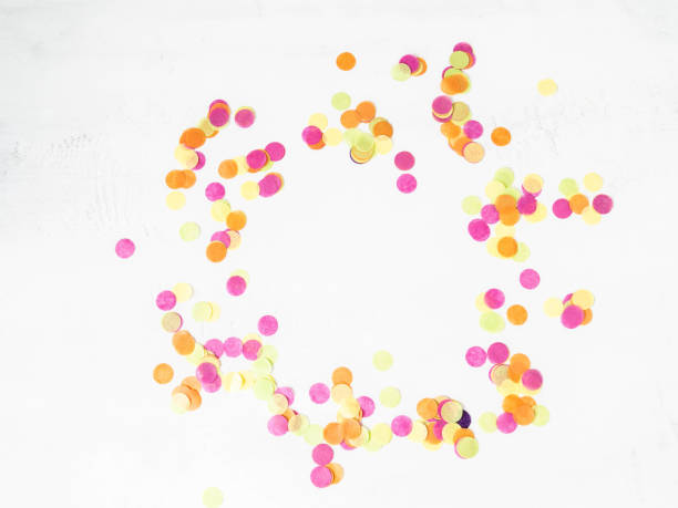 istock Colorful paper confetti scattered on a white background. Top view 1252458749