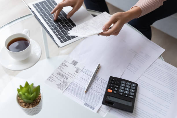 istock Top view close up woman calculating bills, using laptop 1252459207