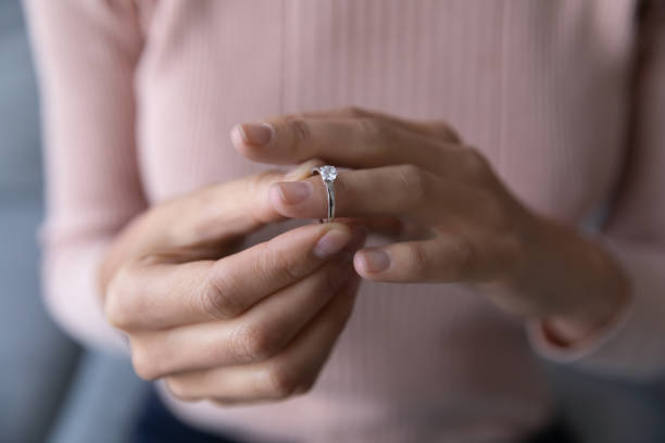 istock Close up woman taking off wedding ring, divorce concept 1252459243