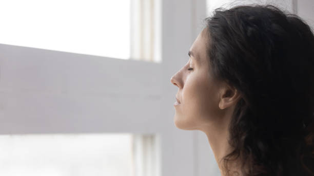 istock Close up mindful thoughtful woman with closed eyes meditating 1252459271