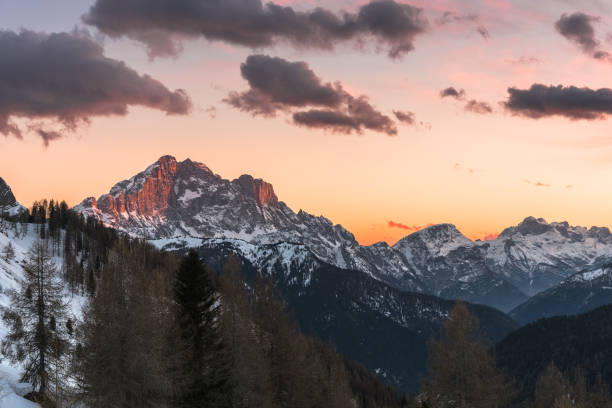 istock Sunset over mountain peaks covered in snow 1252460614