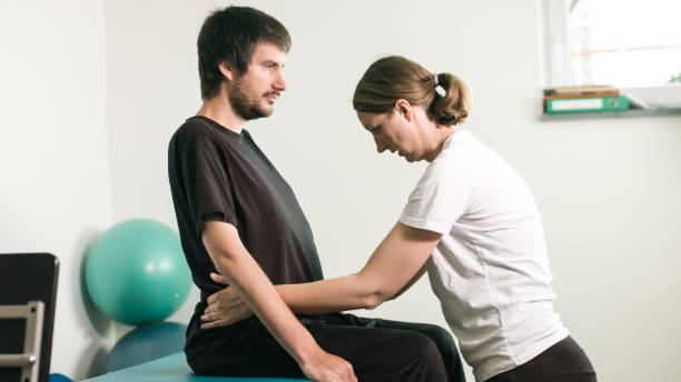 istock Physiotherapist with disabled person 1252460696