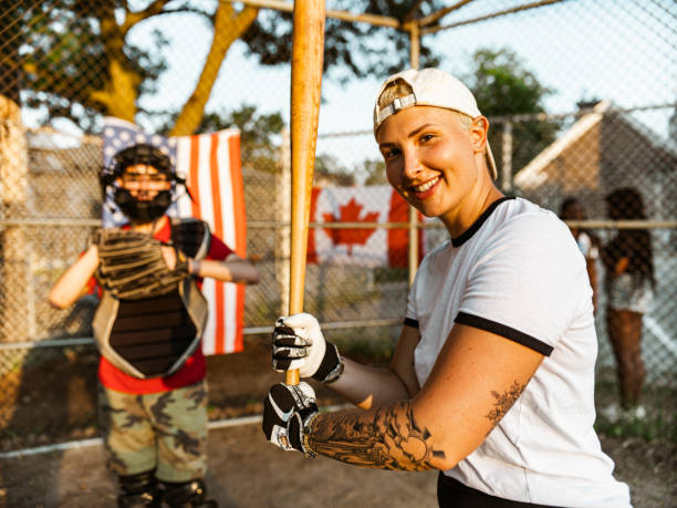istock Young woman playing softball 1252460749