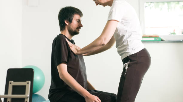 istock Physiotherapist with disabled person 1252460761