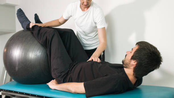 istock Physiotherapist with disabled person 1252460785