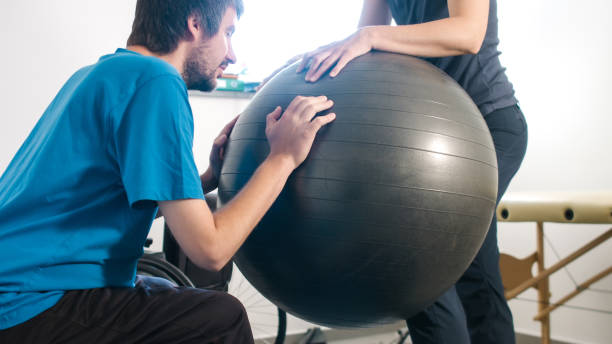 istock Physiotherapist with disabled person 1252460797