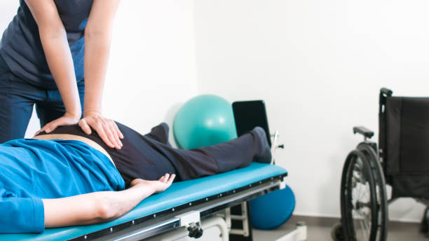 istock Physiotherapist with disabled person 1252460820