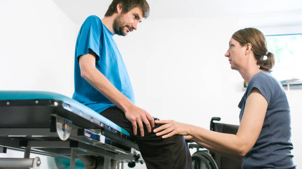 istock Physiotherapist with disabled person 1252460825