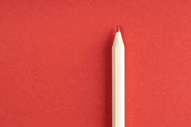 istock Wooden red pencil on red background 1252461053
