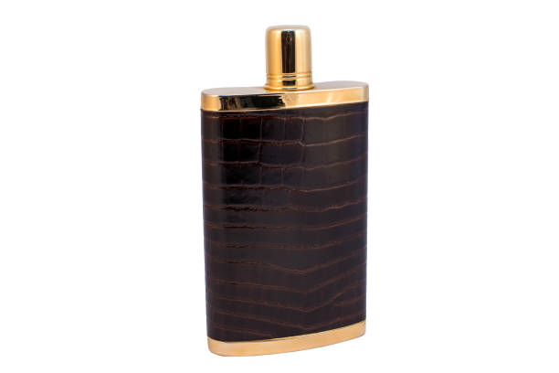 istock Flask for alcohol trimmed with leather and gold lid on a white background, isolated 1252463746