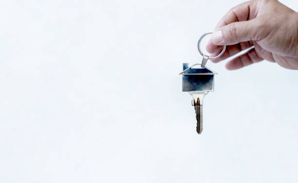 istock real estate concept key and hand 1252470928