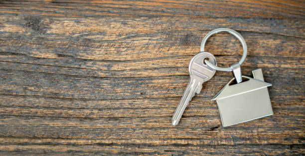 istock real estate concept key and hand 1252471011