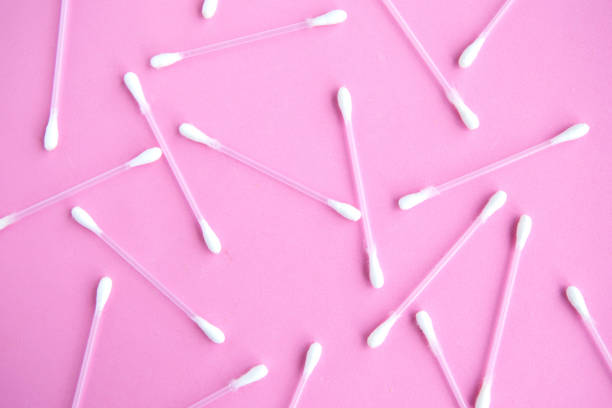 istock Cotton buds pattern on pink pastel background, top view 1252475233