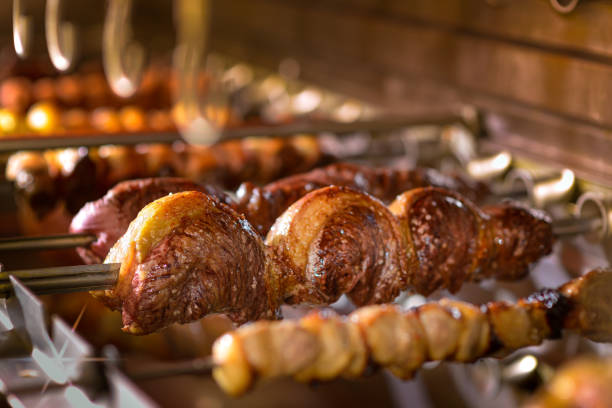 Picanha barbecue roasted over hot coals. Brazilian cuisine. This form of barbecue is widely consumed throughout Brazil. barbecue beef stock pictures, royalty-free photos & images
