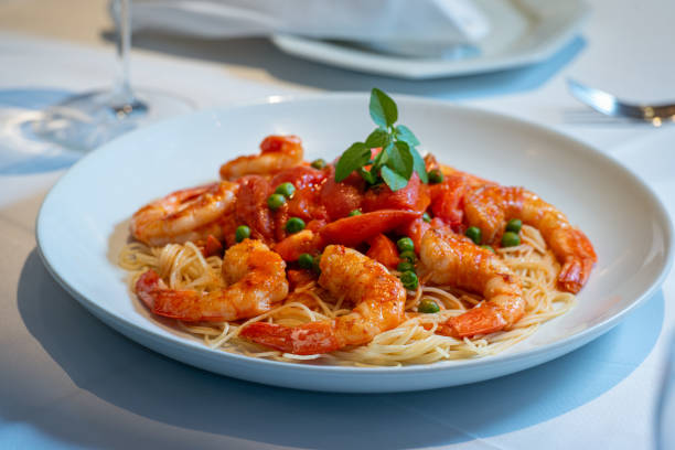 istock Spaghetti dish with shrimp, tomato sauce and peas. 1252480943