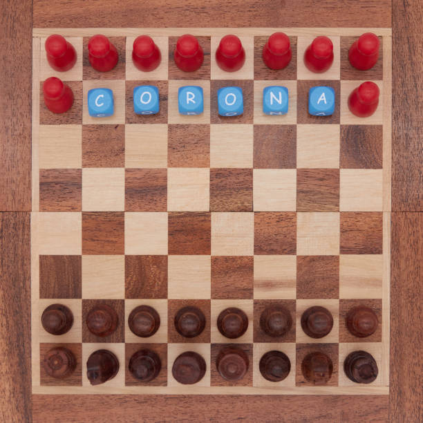 istock Classic black chess pieces compete against red corona players 1252481283