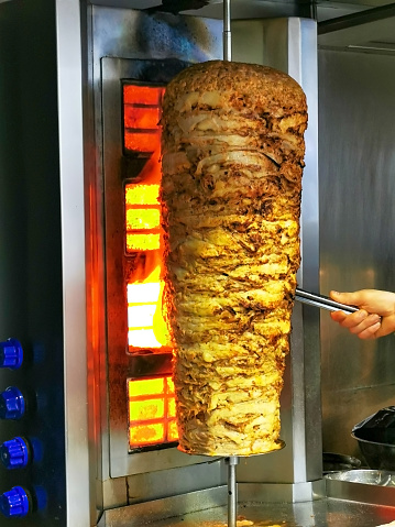 Background image of chicken Shawarma skewers.