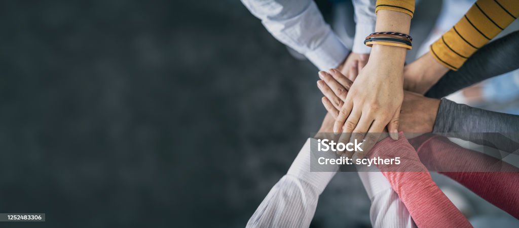 Stack of hands. Unity and teamwork concept. Close up top view of young business people putting their hands together. Stack of hands. Unity and teamwork concept. Teamwork Stock Photo