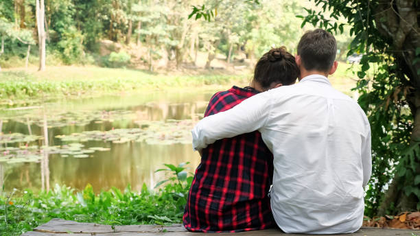 istock young man sits near dark haired woman and hugs with love 1252483473