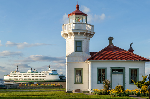 Victorian-style Mukilteo Lighthouse and docked ferry on Pacific Northwest coast, Washington state, USA