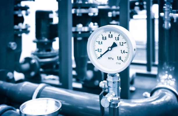 the equipment of the boiler-house, - valves, tubes, pressure gauges, thermometer. close up of manometer, pipe, flow meter, water pumps and valves of heating system in a boiler room. - boiler power station fuel and power generation gas boiler imagens e fotografias de stock