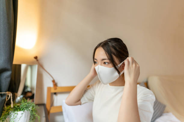 istock Asian woman taking off the mask 1252493309