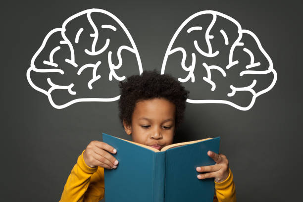 istock Cute black child reading book on chalkboard background, education concept 1252494220