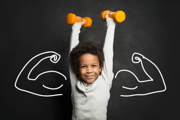 istock Strong black child boy with dumbbells 1252494229