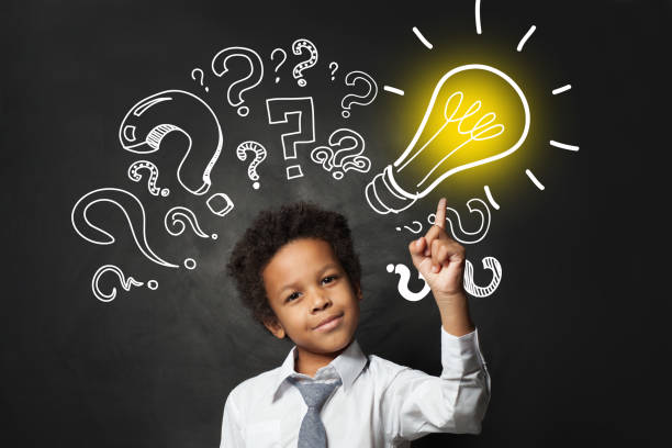 istock Successful black child student pointing at lightbulb. Brainstorming and idea concept 1252494240