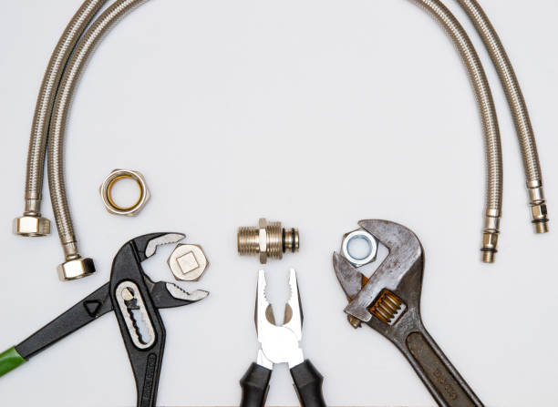 istock Wrench and adjustable spanner, pliers and metal flexible pipes. 1252495123