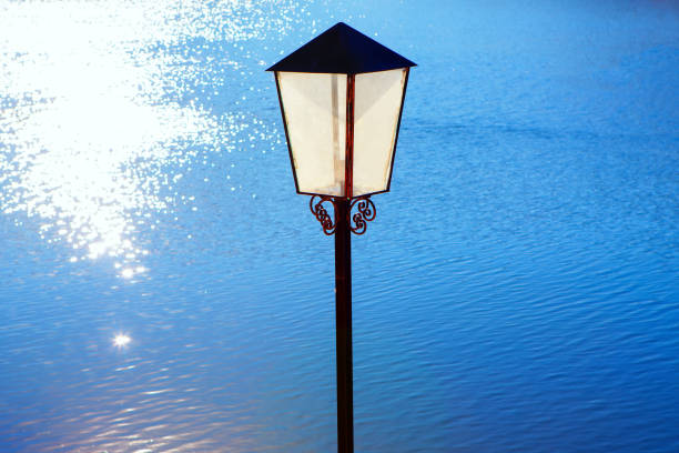 street lamp and sunlight in the blue water