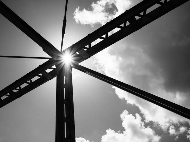 istock Black and white bridge with clouds and sun shining 1252503639