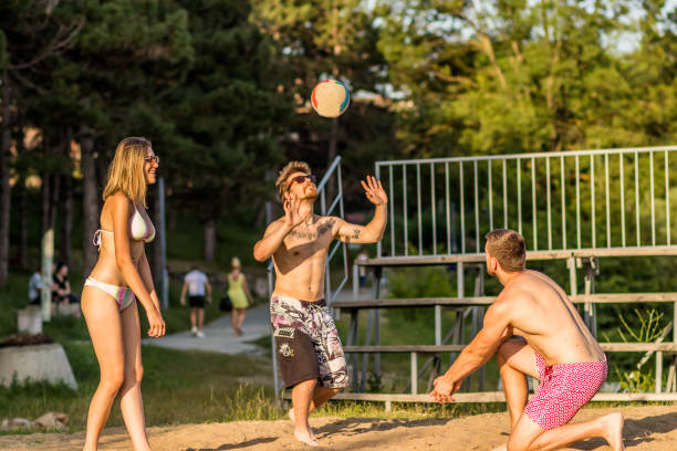 istock Group young Friends Playing Volleyball On Beach 1252504289