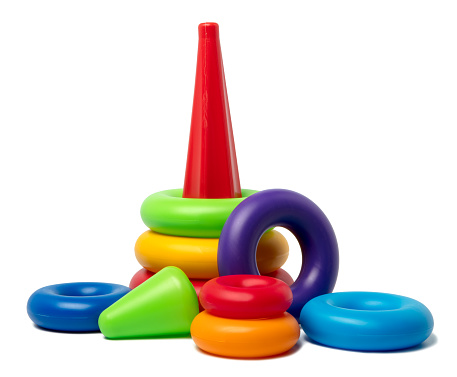 A DSLR photo of a plastic pyramid toy isolated on a white background.