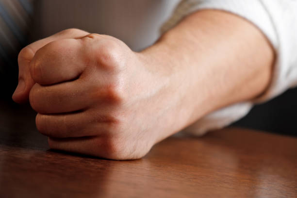 istock Man hitting desk with clenched fist 1252506528