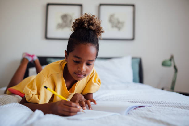 istock Little African American girl doing homework 1252506583