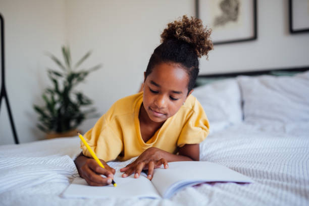 istock Little African American girl doing homework 1252507150