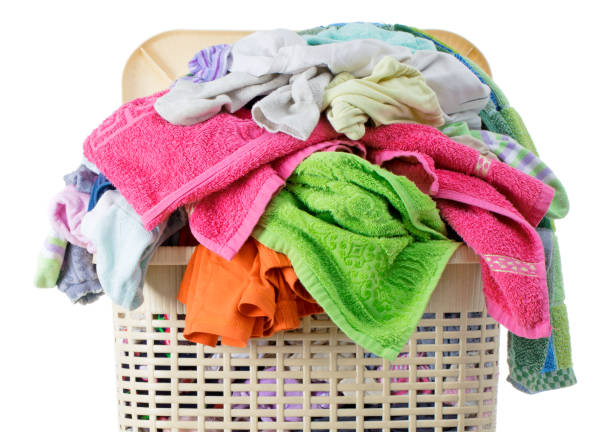 istock Laundry basket full of dirty washing (isolated on white) 1252507200