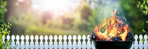 Grill With Wood Fire In Backyard