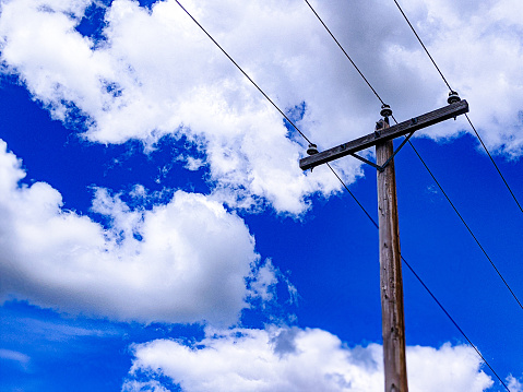 This photo shows a utility pole in a cloudy day.