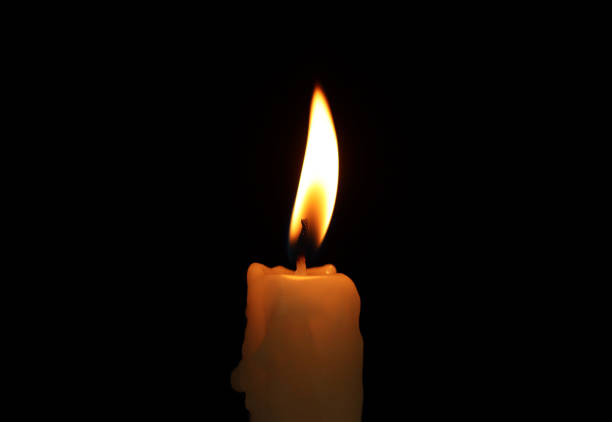 istock One candle in a black background 1252534769
