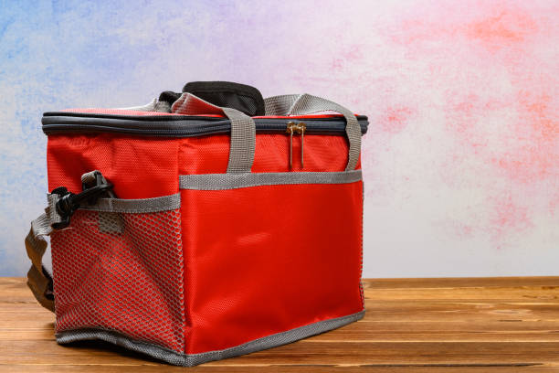 red lunch pack carrier or insulation bag on a wood table