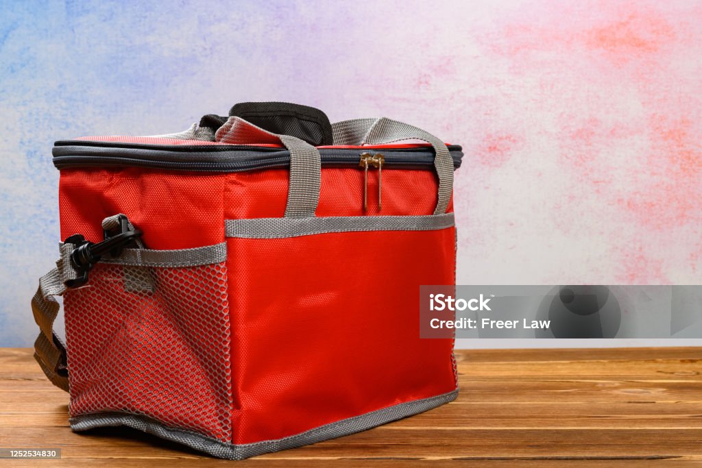 red lunch pack carrier or insulation bag on a wood table Cooler - Container Stock Photo